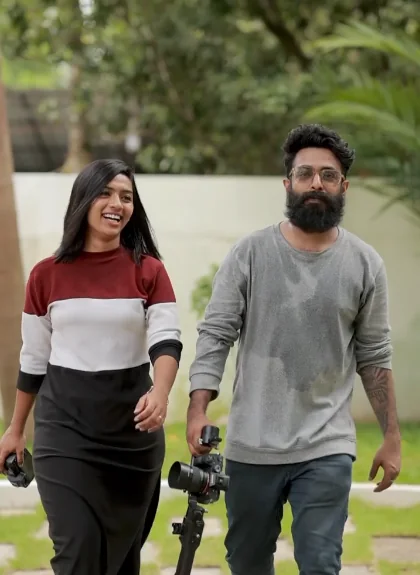 Aleena Gilbert and Althaf P Rasheed walking to a shoot with a camera